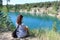 Woman in a striped T-shirt sitting on shore of a lake, Marmara Lake, Novosibirsk Region, Russia
