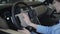 Woman strokes the steering wheel with her hands and touching control panel close up. Modern girl examining automobile in