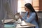 Woman stroking cat at table. Home office concept