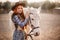 A woman stroking a horse at a ranch.