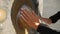 Woman Stroking the Religious Gong with Hands in Buddhist Temple for Clean Karma. HD. Phuket, Thailand.