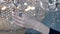 woman is stroking shiny crystal chandelier, closeup of hand, romantic and dramatic