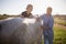 Woman stroking while vet giving injection at horse