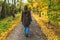 Woman strolling on empty park alley