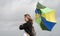 Woman struggling to hold her umbrella on a windy day