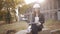 The woman student architect on a construction site examines the technical documentation and makes notes in his notebook