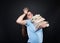 Woman student with desperate look carrying many books