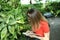 Woman student woman studying plants in a garden