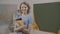 Woman student or woman teacher holding books in the classroom. Ready for school. Smiling female lecturer in class