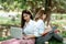 Woman students studying in a group project in the park of university or school. Happy learning, community teamwork and