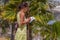 Woman studing plants in botanical garden in tropical part.