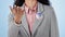 Woman in studio with campaign to vote, badge and hand showing choice for government support. Politics, voting register