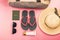 Woman stuff such as luggage bag, hat, slippers, lotion, sunglasses and passport for traveling