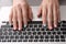 Woman with stylish color nails using laptop, closeup