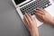 Woman with stylish color nails using laptop on table, closeup