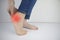 Woman suffering from heel pain. Inflammation or sprain of the tendon in the foot, heel spur, bursitis. The concept of diseases and