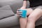 Woman suffering from pain in knee, using cold-hot pack to relieve pain. Health care concept.