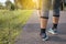 Woman suffering from pain in leg or shin injury after running jogging sport exercise and workout outdoor