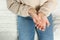 Woman suffering from trigger finger on bed, closeup