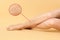 Woman suffering from varicose veins on pastel gold background, closeup. Magnified skin surface showing affected area