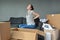 Woman suffers from back pain due to unpacking boxes