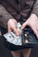 Woman in suit with leather purse full of money