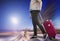 Woman with suitcase awaiting aircraft