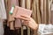 Woman with suitcase holding passport with boarding pass in female boutique store at the airport duty free.