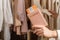 Woman with suitcase holding passport with boarding pass in female boutique store at the airport duty free.