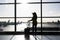 Woman with suitcase standing in airport