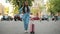 Woman with suitcase waiting taxi in a city