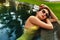 Woman Summer Fashion. Girl Relaxing In Swimming Pool. Beauty