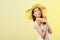 Woman in summer hat holds sunglasses sunscreen lotion