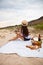 Woman in summer Picnic on the beach at sunset in the white plaid