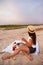 Woman in summer Picnic on the beach at sunset in the white plaid