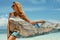 Woman in summer sunbathing on tropical beach on vacation