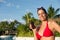 Woman on summer vacation holding suntan lotion bottle