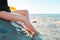 Woman sunbathing on the beach with his feet in the sea water. Feet close up. The concept of holiday resort and travel