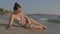 Woman sunbathing on the beach showing legs with bikini beach body and beautiful healthy skin. Female model on vacation