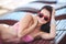 Woman sunbathing in bikini at tropical travel resort. Beautiful young woman lying on sun lounger near pool.