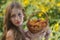 Woman in sunflower chain with a basket of fruit