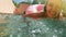 Woman with sunglasses in blue bikini lying in inflatable pink donut float in pool on sunny summer day. Look at camera