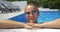 Woman in sunglasses enjoying sunny day in the pool