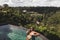 Woman in sunglasses relaxing in luxury infinity pool with jungle view in Ubud