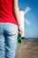 Woman with sunglasses in shape of heart on west breakwater. Windmill Stawa Mlyny in Swinoujscie. Summer and vacation time