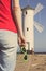 Woman with sunglasses on west breakwater in Swinoujscie by characteristic navigational mark Windmill Stawa Mlyny. Vacation time