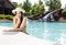 Woman with sunhat at pool