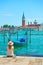 Woman with sunhut at quayside in Venice