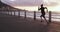Woman, sunrise and running at beach for fitness, action and speed training for marathon. Fast athlete, sports and runner