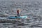 Woman on sup board. Young woman on a paddle board on a summer day